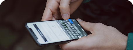 A person typing and sharing a review on a mobile phone keyboard